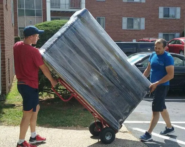 Movers unloading household items